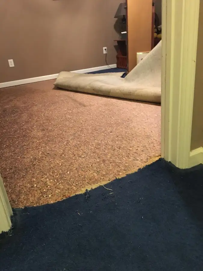 Carpet pad removal revealing water damage during Water Mitigation Services in Guymon